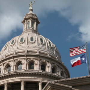 Texas Capitol with US and Texas flags flying